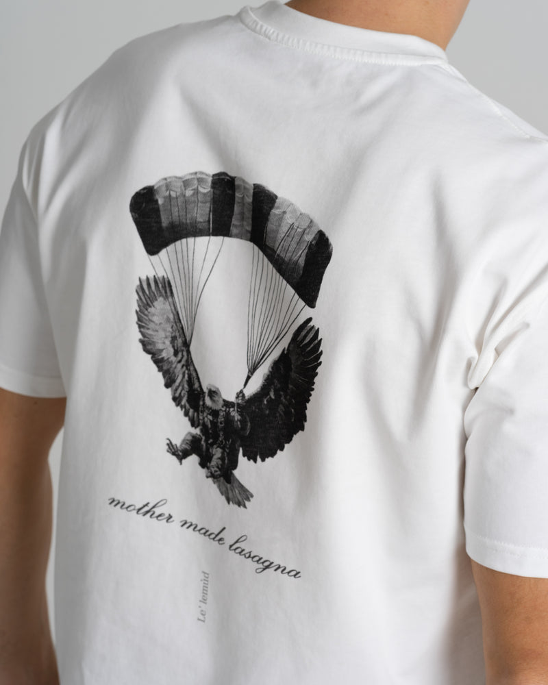 Close-up of premium white Le Lemud oversized t-shirt back graphic featuring eagle with parachute and mother made lasagna text