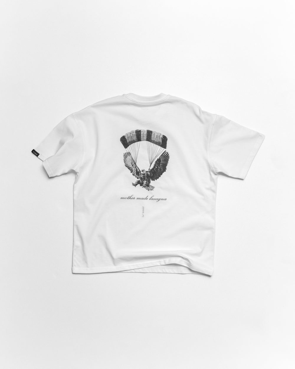 White oversized t-shirt with premium black eagle design on a white background by le lemud luxury streetwear