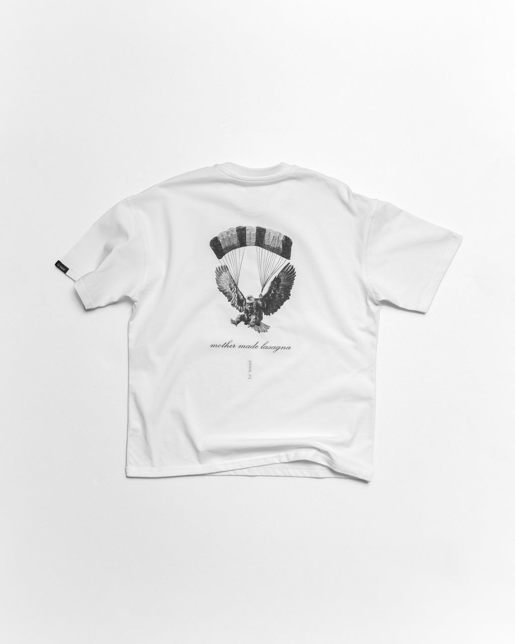 White oversized t-shirt with premium black eagle design on a white background by le lemud luxury streetwear